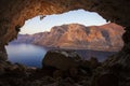 Male rock climber climbing along roof in cave before sunset. Royalty Free Stock Photo