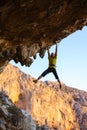 Male rock climber hanging on roof of cave Royalty Free Stock Photo