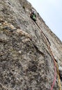 Male rock climber on a hard and steep climbing route in the granite walls of the Val Bregaglia in Switzerland Royalty Free Stock Photo