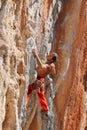 Rock climber leaging climbing route on natural rock Royalty Free Stock Photo