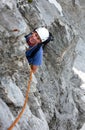 Male rock climber on a steep climbing route looks up and smiles Royalty Free Stock Photo