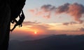 Male rock climbing pulling up, doing next step reaching top. Side view. Panoramic mountain view and sunset. Copy space