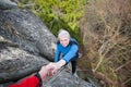 Male rockclimber is helping a climber female Royalty Free Stock Photo