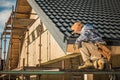 Male Roof Contractor Reviews Project Progress