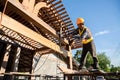 A male roofer carpenter working on roof structure on construction site Royalty Free Stock Photo