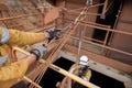 Rope access industry worker hand wearing hand safety glove protection, while using mechanical advantage three two one pulley