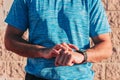 Male runner and athlete using his smartwatch to monitor and motorize his consistent health during exercise and outdoor training.