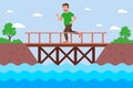 male runner crosses the river over a wooden bridge. Royalty Free Stock Photo