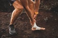 Male runner holding injured bandaging leg close-up Royalty Free Stock Photo