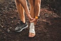 Male runner holding injured bandaging leg close-up Royalty Free Stock Photo
