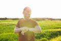 Close-up of Male runner jogging outside looking at his wearable fitness tracker outside.