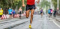 male runner leader running marathon city race
