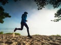 Male runner run hard in white sand of beach