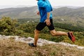 male runner in windbreaker and tights running along precipice Royalty Free Stock Photo