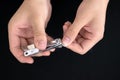 Male`s hand holding on nail clippers,Man use nail clipper cutting their thumbs nail on background