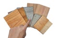 male's hand picking wooden vinyl flooring tiles, engineering flooring tiles, laminated veneers samples.