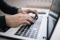 Male`s hands typing on a laptop keyboard Royalty Free Stock Photo