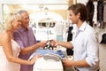 Male Sales Assistant At Checkout Of Store Royalty Free Stock Photo