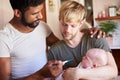 Male Same Sex Couple Checking Baby Daughters Temperature In Bathroom At Home Royalty Free Stock Photo