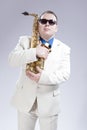 Male Saxophone Player Posing With Alto Saxo In White Suit and Sunglasses