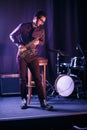 Male saxophone player on a stage. Royalty Free Stock Photo