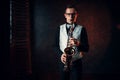 Male saxophonist playing jazz melody on saxophone