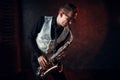 Male saxophonist playing jazz melody on saxophone