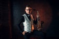 Male saxophonist posing with saxophone, jazz man