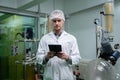 Scientist, apothecary working in laboratory for cannabis extraction with tablet.