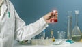 Male scientist holding in hand flask lab glassware in chemical laboratory background, science laboratory research and Royalty Free Stock Photo