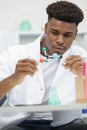 male scientist holding molecular model in lab