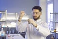 Male scientist investigator in safety glasses and gloves working with test tube Royalty Free Stock Photo