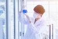 Male scientist looking at flask with blue liquid Royalty Free Stock Photo