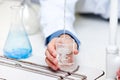 Male scientist pouring liquid into a becher Royalty Free Stock Photo