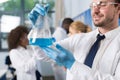 Male Scientist Working With Flask In Laboratory Making Research Over Mix Race Team Of Lab Workers Royalty Free Stock Photo