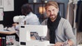 Male seamstress sitting sewing machine