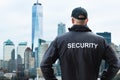 Male Security Guard Looking At City Skyline In Manhattan