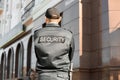 Male security guard outdoors, back view