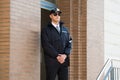 Male Security Guard Standing At The Entrance Royalty Free Stock Photo