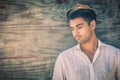 Male seduction. Young man in profile on antique wooden background. Royalty Free Stock Photo