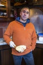 Male seller chef baker with sandwich on kitchen