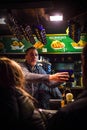 A seller in the Christmas fair kiosk gives the mugs with mulled wine to the customers in Vienna, Austria