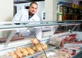 Male seller in halal section at supermarket