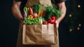 male seller hands holding a paper bag with vegetables in the market. delivery of healthy and fresh food. AI. Royalty Free Stock Photo