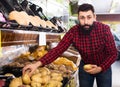 male seller moving fresh vegetables