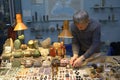 Male seller placing piece of jewelry on the counter preparing his stall for opening Royalty Free Stock Photo