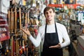 Male seller posing at tooling section of household store