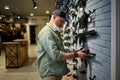 Male seller at showcase with rifles in gun store Royalty Free Stock Photo