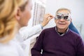 Male senior examine eyes Royalty Free Stock Photo