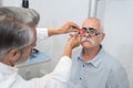 Male senior in eye clinic examine eyes Royalty Free Stock Photo